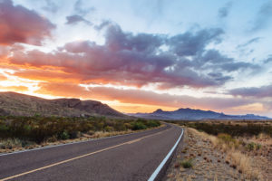 Two lane highway at dusk in the Chisos Mountains in Big Bend National Park, Texas
