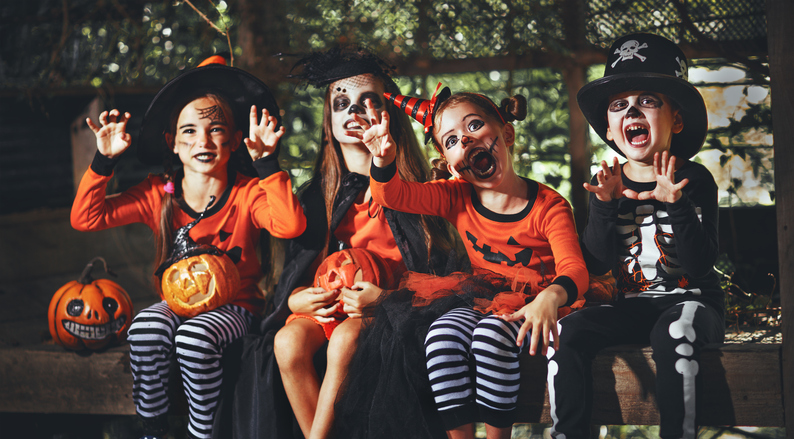 A group of children in halloween costumes