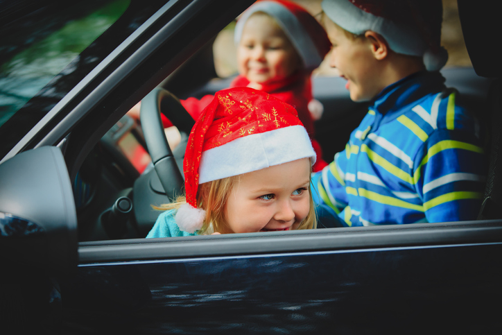 christmas car travel- happy kids travel by car in winter